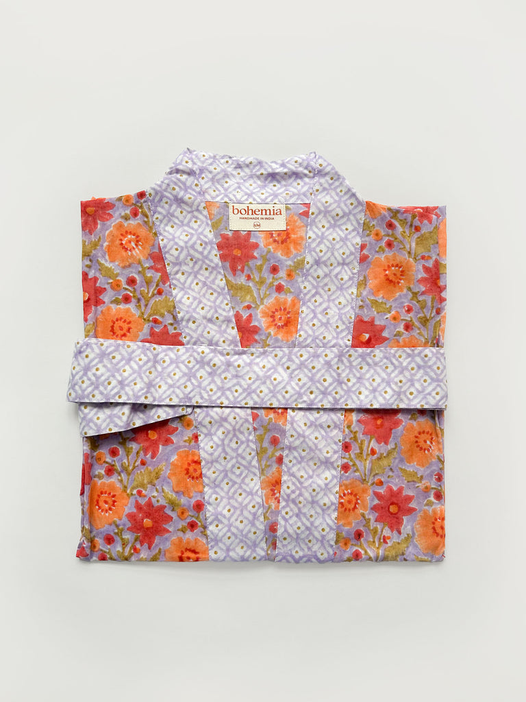 Flat-folded cotton robe in lilac with complementary block print floral patterns on a white background | Bohemia