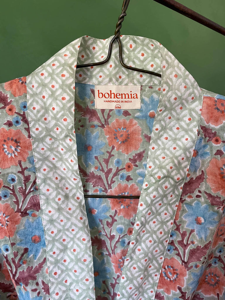 Close-up of a block print cotton robe in soft green, blue, and faded terracotta, showing floral details and the Bohemia label | Bohemia