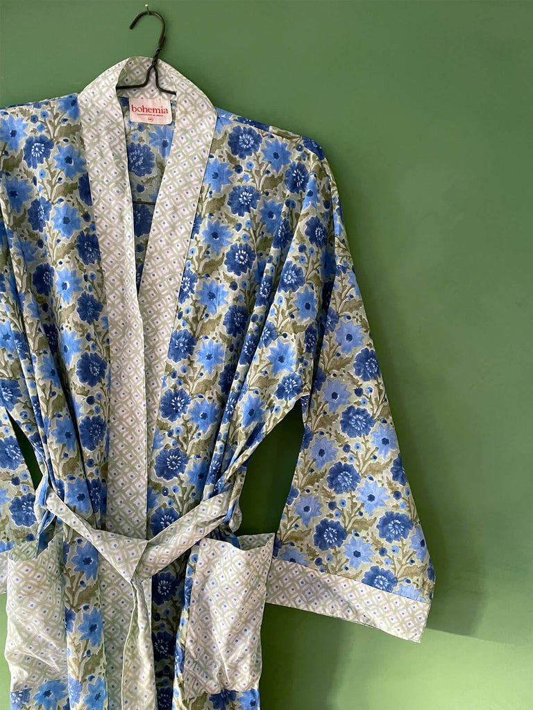 Close-up of a block print cotton robe in sage with contrasting ditsy floral print on the cuffs, pockets, trim, and belt | Bohemia