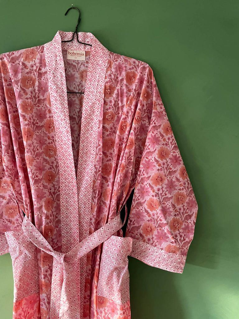 Close-up of a block print cotton robe in vintage pink with contrasting ditsy floral prints on the cuffs, pockets, trim, and belt | Bohemia