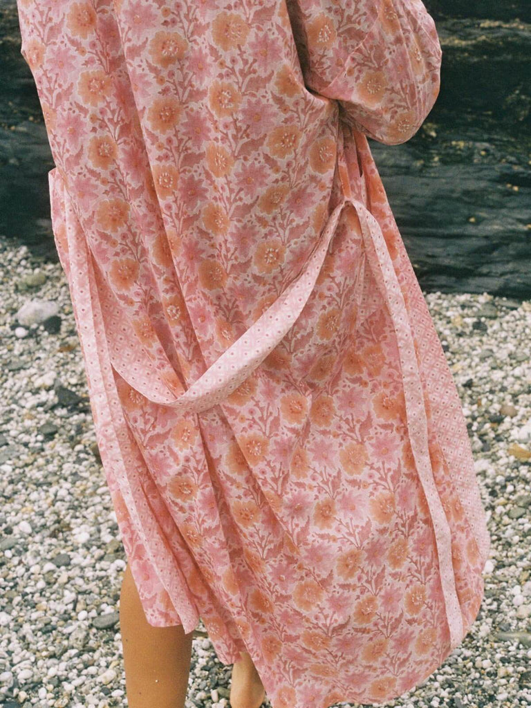 Detail of the back of a vintage pink block print robe with tie.