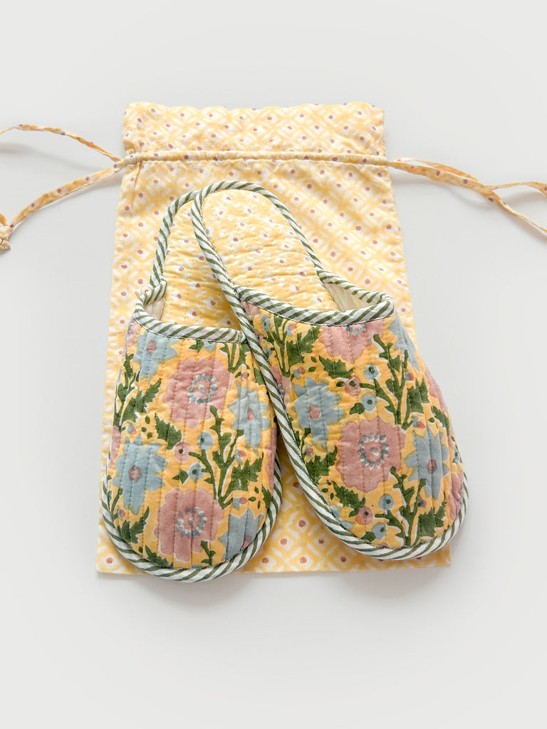 Buttermilk yellow house slippers with a lining in a contrasting Ditsy print and a matching cotton voile drawstring bag by Bohemia Design