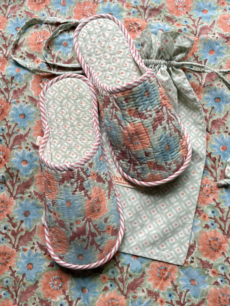 Soft, lightweight Floribunda-patterned house slippers with a ditsy print drawstring bag shown on a matching floral background, Duck Egg | Bohemia.