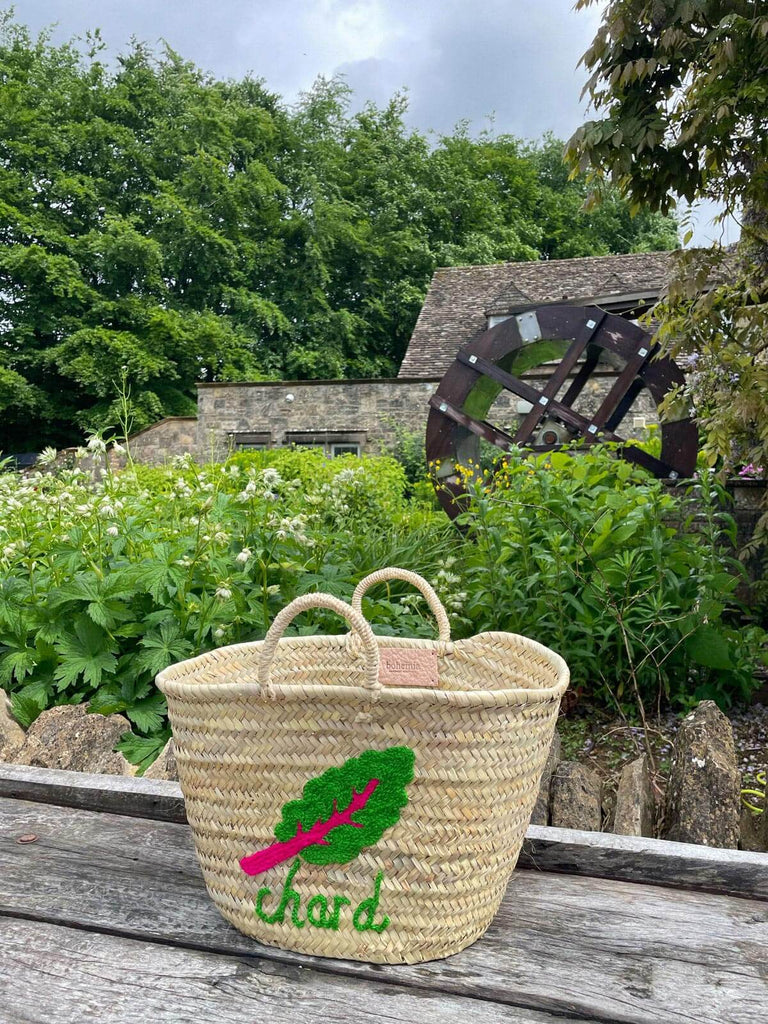 Hand embroidered woven basket bag with small handles featuring chard illustration nestled within its natural garden setting | Bohemia Design