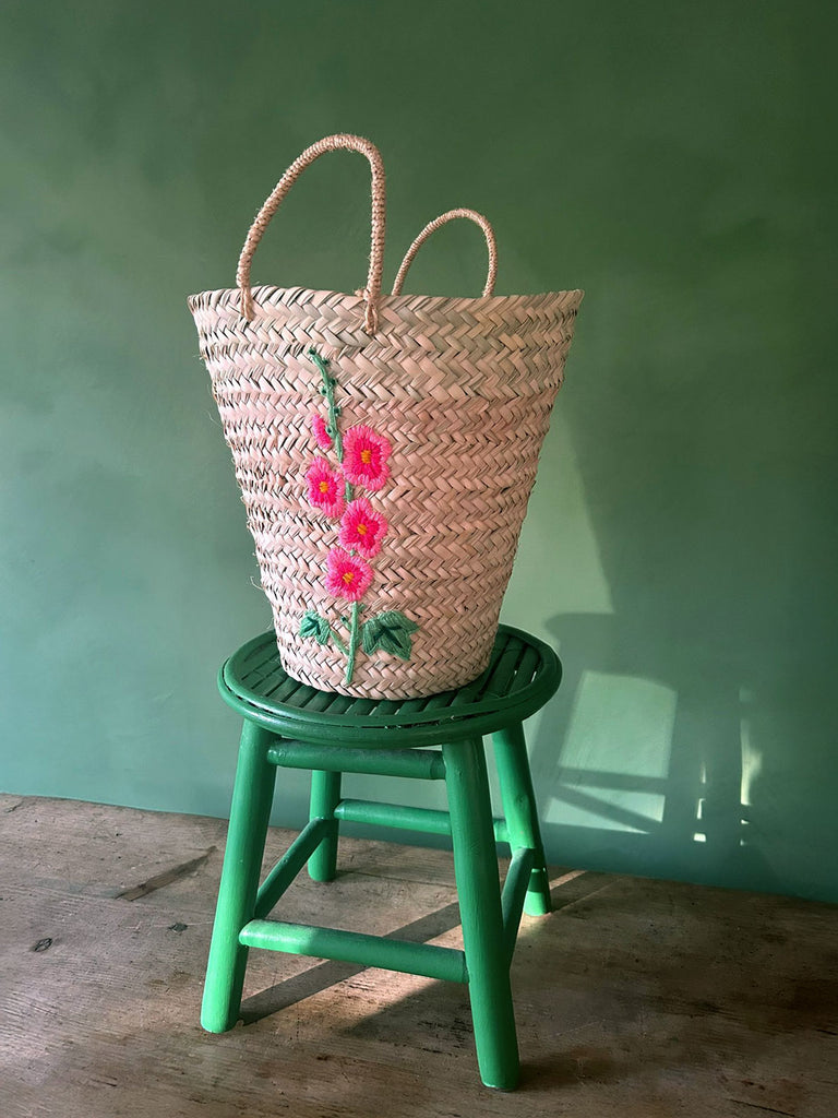 Wholesale handcrafted bucket basket hand-embroidered with a charming hollyhock flower in vibrant pink hues | Bohemia Design