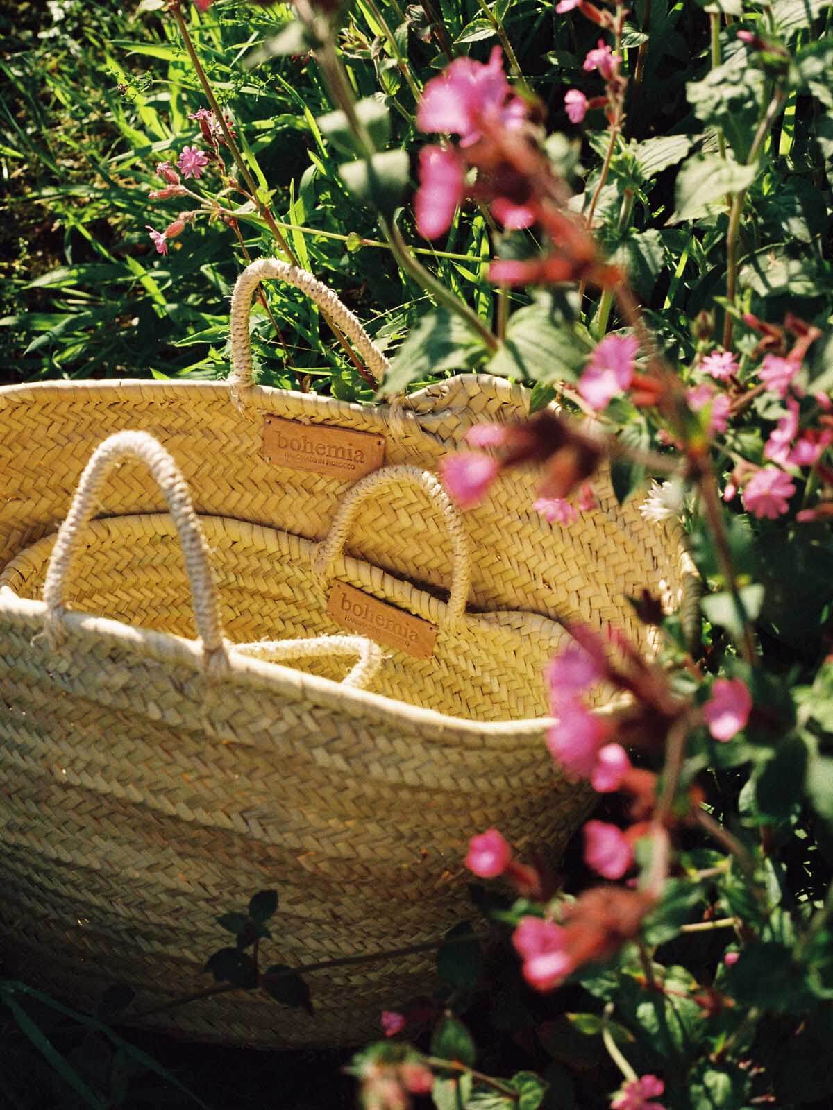 A medium and small Market Basket surrounded by wildflowers