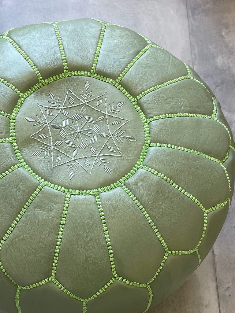 Close-up of a Moroccan leather pouffe in sage, highlighting intricate stitching details by Bohemia Design
