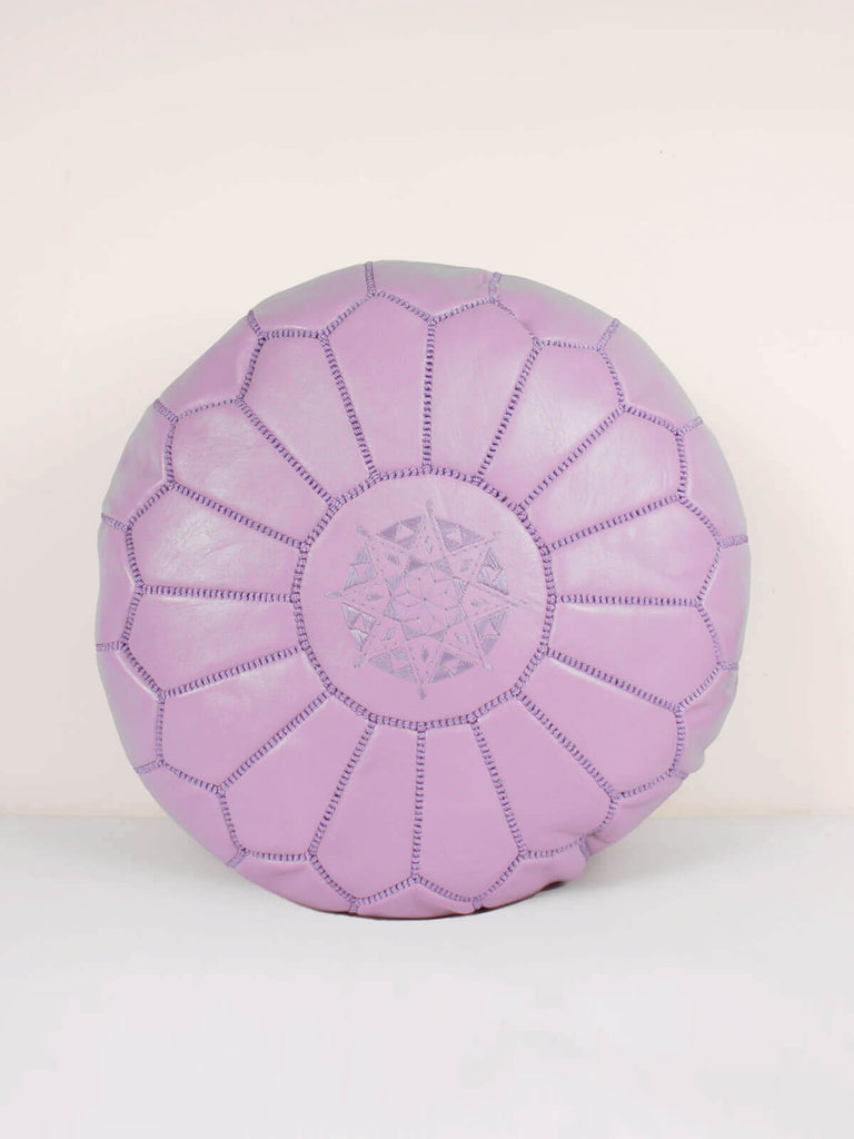 Traditional Moroccan leather pouffe in contemporary vintage pink with hand embroidered panel