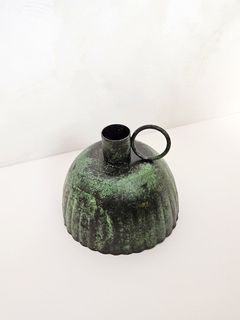 Top view of Petticoat iron candle holder with a vintage finger hold in a rustic green-moss finish | Bohemia