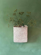 Moroccan hanging wall basket filled on a green background