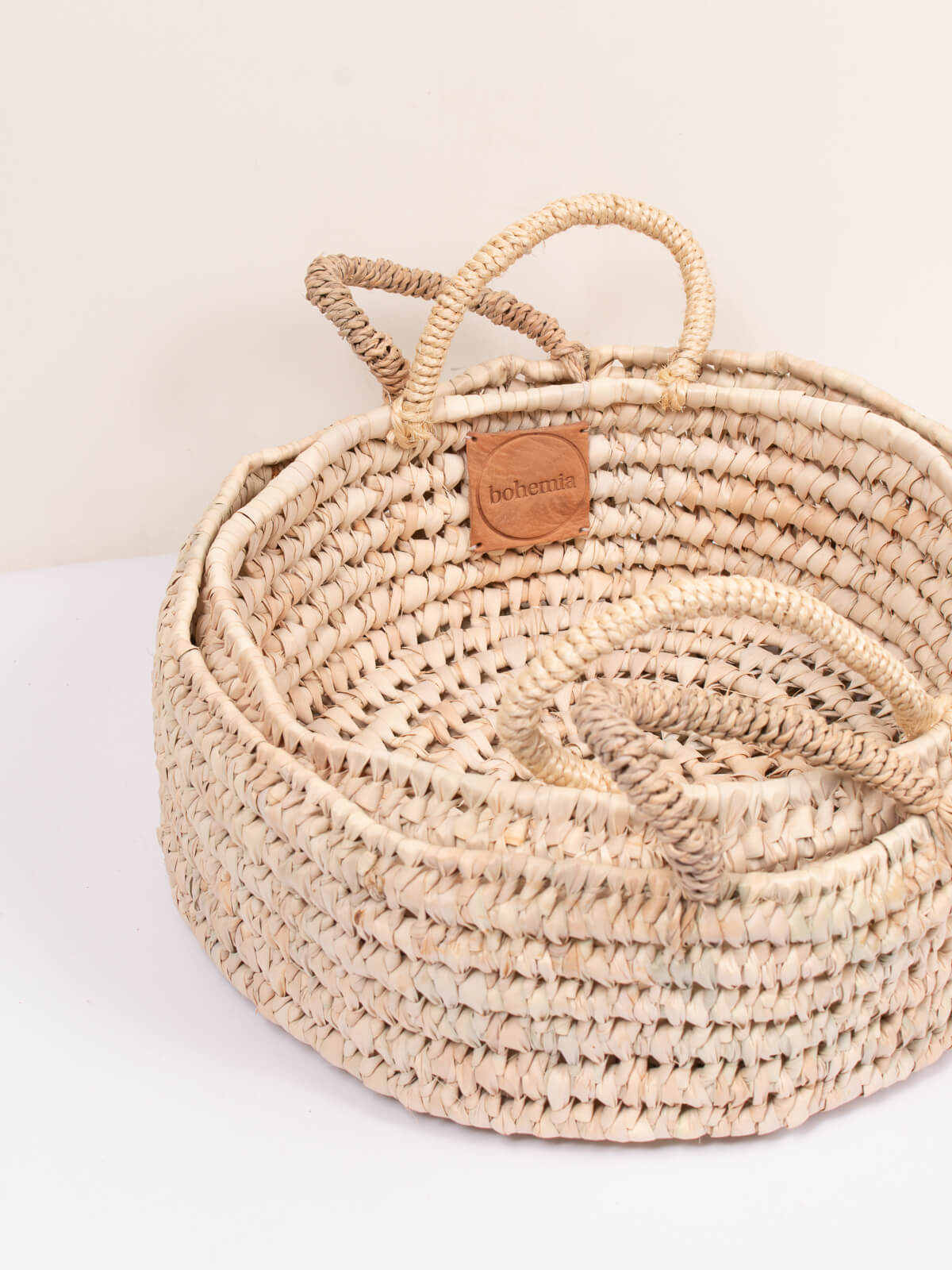 Two nesting open weave storage baskets with round shape and handles ideal as a deep tray or catch all basket