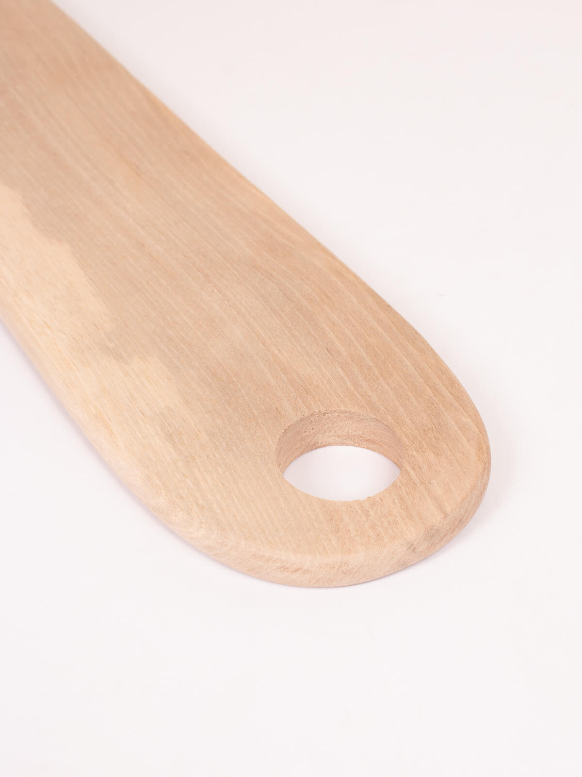 Close up of simple handle on the long walnut wood serving board